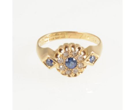 A sapphire and diamond cluster ring, a circular sapphire surrounded by eight small old cut diamonds in an 18 carat all yellow