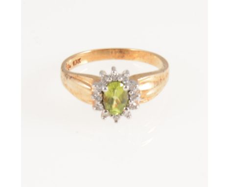 A peridot and diamond oval cluster ring, the oval mixed cut peridot surrounded by twelve eight cut diamonds in a yellow and w
