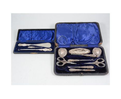 A silver manicure set by Henry Matthews, cased, blue velvet lining, Birmingham 1899-1901 and Chester 1900, and a silver-handl