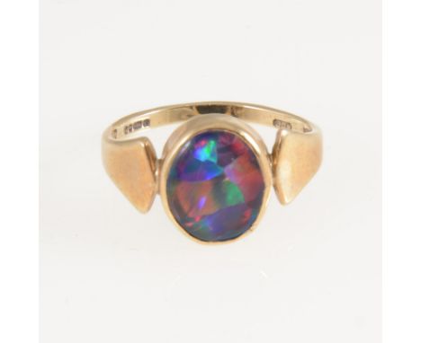 An opal dress ring, the oval cabochon cut opal triplet, 11mm x 9mm, collet set in a 9 carat yellow gold mount with wide polis