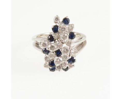 A modern sapphire and diamond dress ring, ten round cut sapphires and nineteen brilliant cut diamonds claw set in an all whit