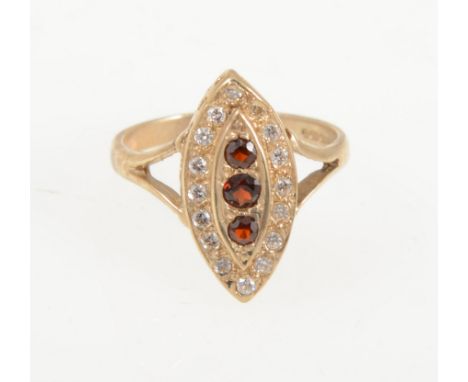 A modern 9 carat yellow gold marquise cluster ring set with three vertical garnets and a border of sixteen synthetic white st