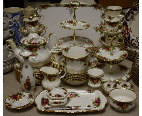 A Royal Albert Old Country Roses pattern dinner and tea service, comprising teapot, milk and sugar, two cake stands, cups and