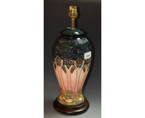 A Moorcroft pottery lamp base, Stylised Trees design, wooden base, 29cm high