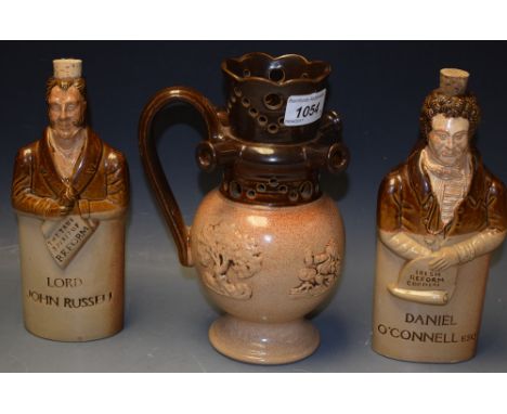 A Bourne Denby reproduction reform flask, Daniel O'Connell; another, Lord John Russell; a puzzle jug (3)