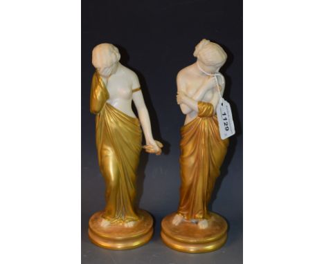 A pair of  Royal Worcester figures, Joy and Sorrow, the classical maidens stands, semi-nude, one with  her face buried in her