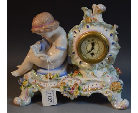 A Continental mantel clock, flower encrusted, young child with book