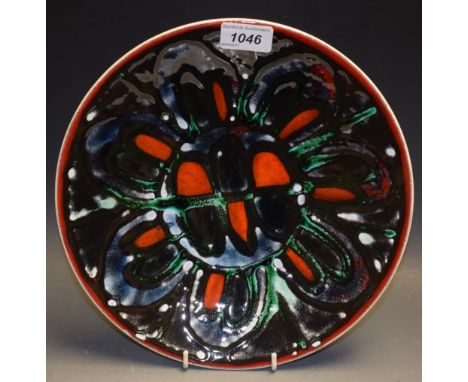 A Poole Pottery Adephis bowl, decorated with a black, burnt orange and green seven petal flower, printed and painted marks, 2