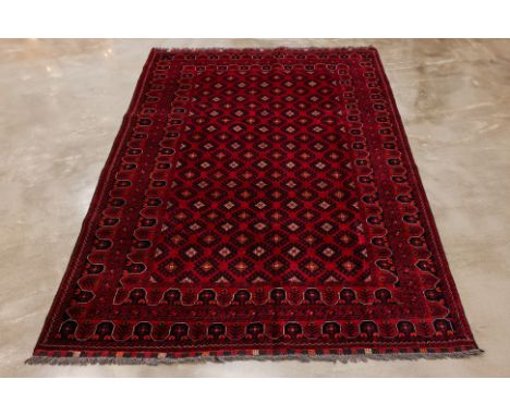 AN AFGHAN SARUK DESIGN WOOL CARPET (300 x 202cm)
Hand knotted wool, all over design on a red ground
Condition: For a conditio