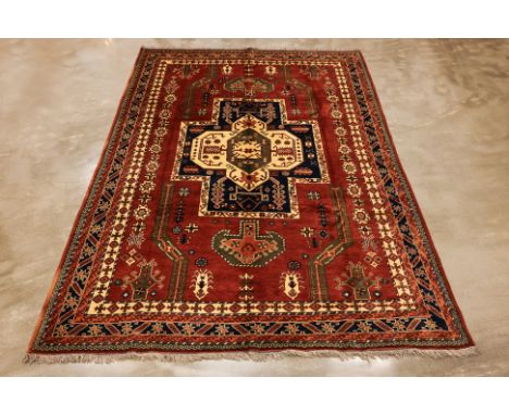 A TURKMEN HERIZ DESIGN WOOL CARPET (300 x 217cm)
Hand knotted wool, medallion design
Condition: For a condition report or fur