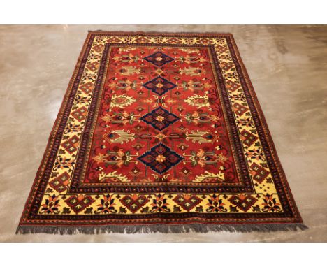 A TURKMEN WOOL CARPET (296 x 220cm)
Hand knotted wool, stylised floral design on a burnt sienna field
Condition: For a condit