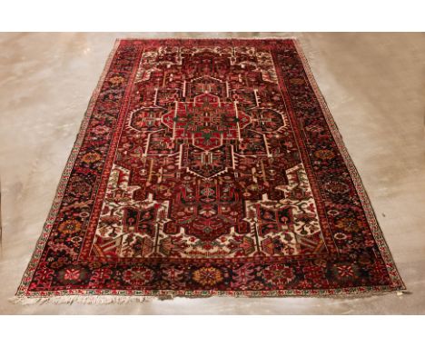 AN ANTIQUE LARGE HERIZ WOOL CARPET (350 x 248cm) Early 20th century, hand knotted wool, of typical geometric design Condition