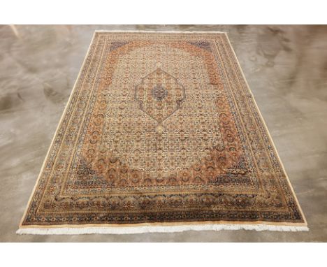 A LARGE KHOR MAHI DESIGN WOOL CARPET (363 x 244cm) Hand knotted wool, circa 1990s Condition: For a condition report or furthe