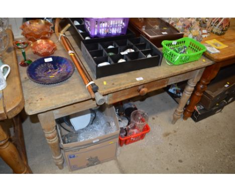 A pine single drawer kitchen table raised on ring turned supports 