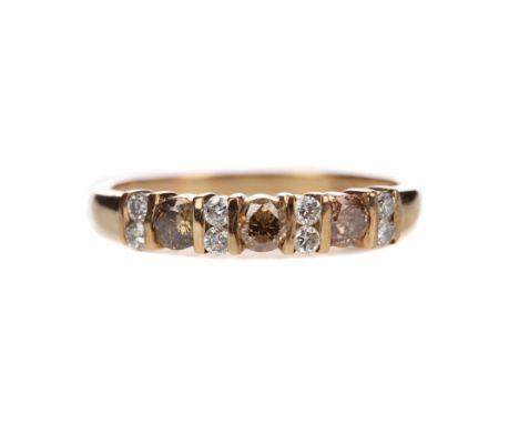 DIAMOND BAND, set with cognac diamonds interspaced by pairs of diamonds, the diamonds totalling approximately 0.46 carats, in