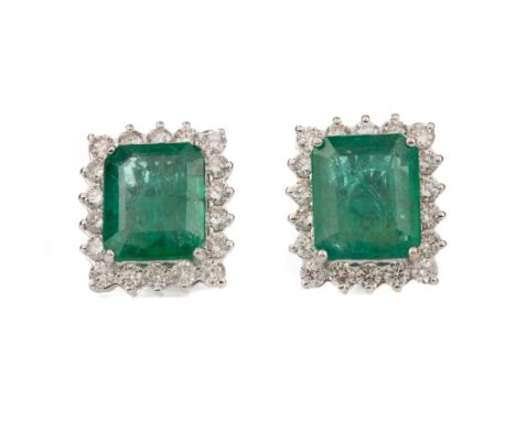 PAIR OF EMERALD AND DIAMOND EARRINGS, set with step cut emeralds totalling approximately 6.10 carats, within round brilliant 