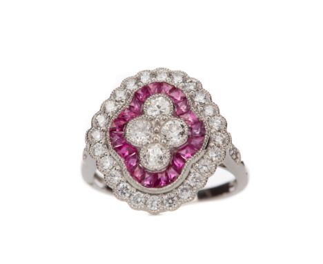 RUBY AND DIAMOND RING, set with old cut diamonds bordered by calibre cut rubies and round brilliant cut diamonds, on diamond 