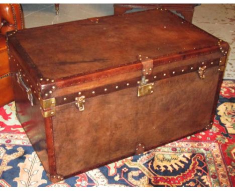STEAMER TRUNK, brown leather bound with brass studs, hinged top and side handles, 51cm H x 91cm x 56cm.