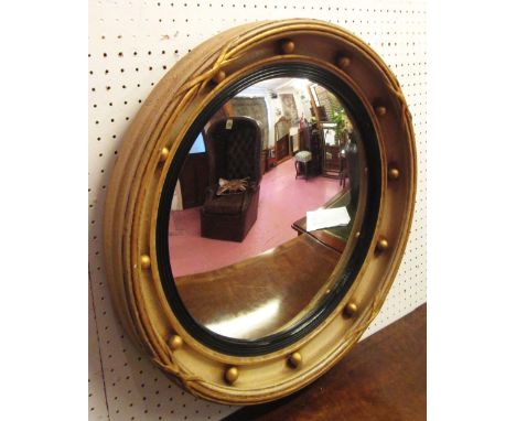 CONVEX WALL MIRROR, Regency style giltwood and painted with punctuated ball decoration, 54cm diam. 