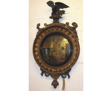 CONVEX MIRROR, Regency giltwood and ebonised with eagle surmount and original plate, 110cm H x 58cm.