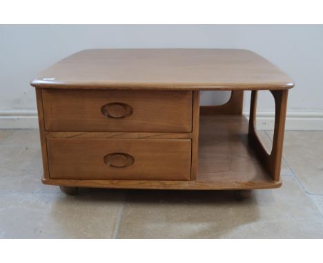 An Ercol blonde elm mid 20th Century Pandora coffee table with a width of 80cm x 81cm x 40cm high. 