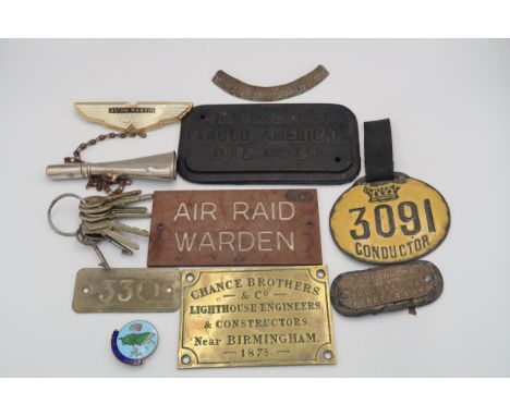 A selection of enamel, brass, metal badges including Aston Martin, Conductors badge, Air Raid Warden, Bakelite plaque etc 
