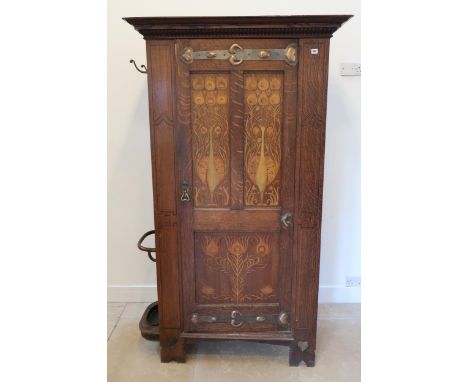 An Arts and Crafts hall cupboard, circa 1900 by Shapland and Petter, Barnstable, combined cupboard and umbrella stand in ligh