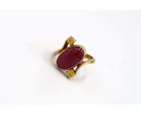 A 9ct Yellow Gold Dress ring with Oval cut red gemstone to shoulder Size R - approx weight 6.3 grams