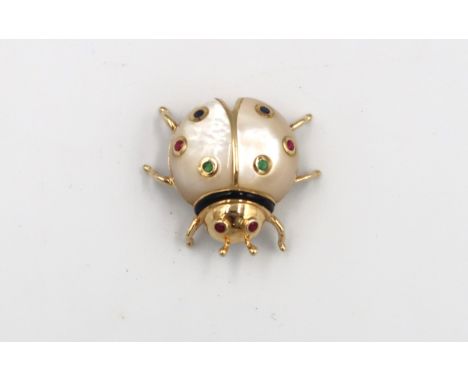 A mother of pearl ladybird brooch with stone collets and black enamel detail. Stamped 14K. Length 27mm, Weight 7.18 grams. 