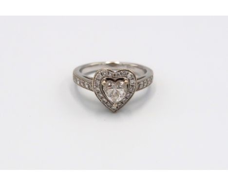 An 18ct white gold heart shaped diamond ring, the heart shaped diamond, estimated 0.80 ct/ H/I, VS/SI, surrounded by 17 small