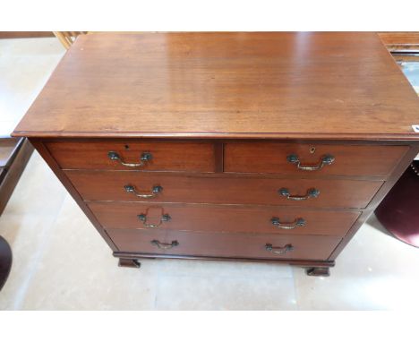 A Georgian mahogany chest of two short over three long drawers raised on bracket supports.