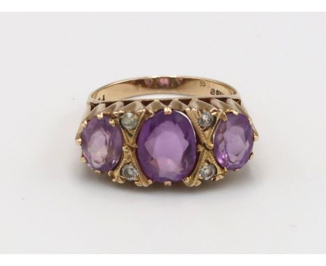A 9ct gold three stone ring set with amethysts - ring size N - weight approx 3.84 grams 