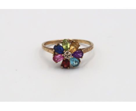 A 9ct Yellow Gold Flower head dress ring, with alternate coloured gemstones to shoulder. Size R - approx weight 2.1grams. 