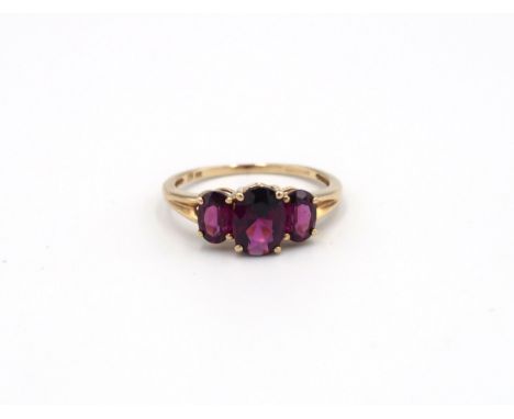 A 9ct yellow gold three stone Almandine garnet ring - garnets are a good colour and well matched - head size approx 14mm x 8m