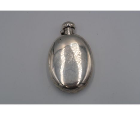 A silver hallmarked hip flask of oval form, A/F, 3.8 troy oz 