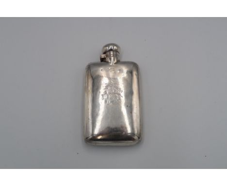 A silver hallmarked hip flask with engraved decoration, 4.64 troy oz 