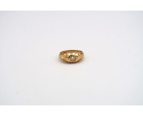 An 18ct yellow gold solitaire ring with foliate engraving to shoulder - weight approx 3.24 grams - ring size J/K 
