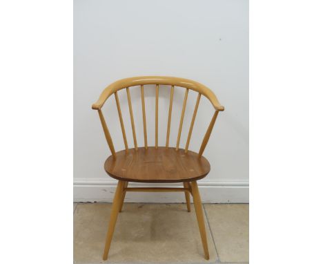 An Ercol blonde elm cow horn lounge chair, label to underside of seat, height to seat 43cm, total height 77cm, width 55cm, de