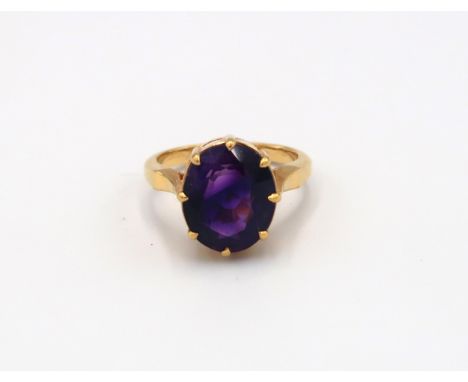 A 22ct Indian gold ring, oval cut amethyst to shoulder - total weight approx 7.19 grams. Size O 1/2 