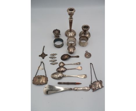 A selection of hallmarked silver, items include napkin rings, whiskey and sherry label, spoons, candlesticks etc 