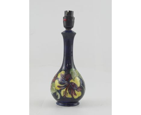 A Moorcroft early/mid-20th century lamp base in the Hibiscus pattern to a blue ground, with original Bakelite fittings, heigh