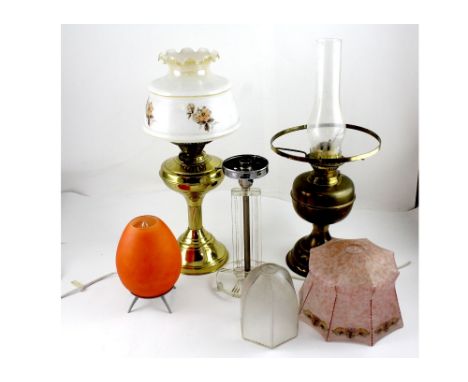 An Art Deco style Perspex and chrome lamp base, height 28.5cm, a 1960s ovoid table lamp and paraffin lamps and shades (6).