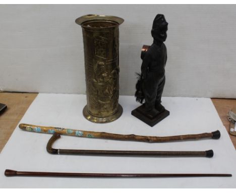 An early 20th century companion set in the form of a Dutch boy and a brass stick stand with three walking canes (5).