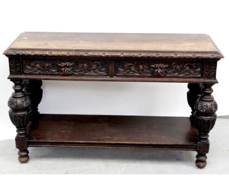 An early 20th century carved oak green man buffet with two frieze drawers supported on bulbous carved and turned legs united 