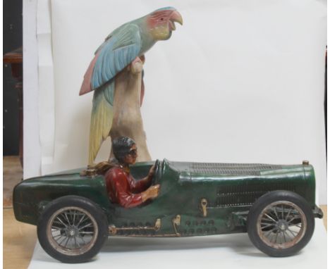 A plastic or composite model 1950s vintage racing car, length 71.5cm and a wooden carved parrot on stand (2).