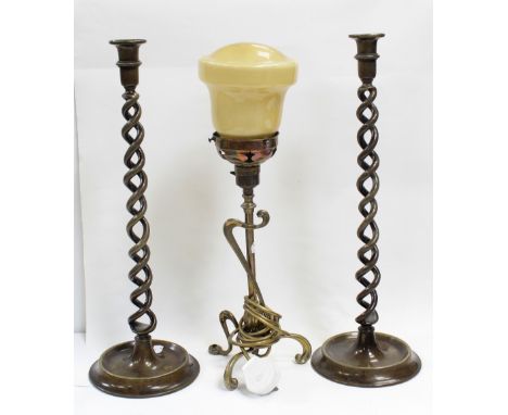 A pair of early 20th century brass wrythen column candlesticks, height of each 50cm and a c1930s brass Art Deco table lamp on