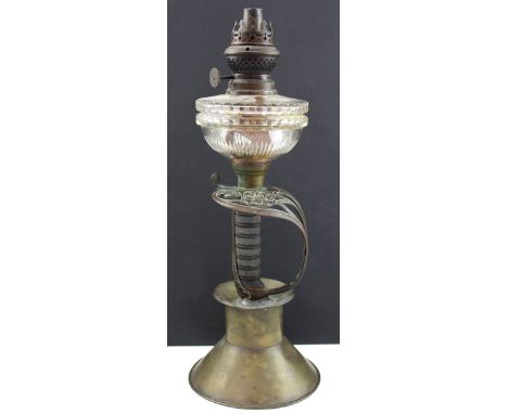 A late Victorian/early Edwardian paraffin lamp, the column made form a Victorian officer's sword handle and hilt, on spreadin