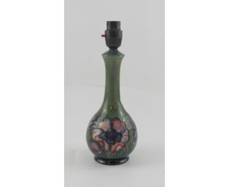 An early Moorcroft Anemone pattern lamp base with green ground, c1940 with original Bakelite fittings, height 21.5cm.