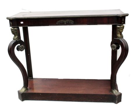 A Regency period rosewood console table with brass inlaid band to top, ormolu rope edging and ormolu decoration of central pa