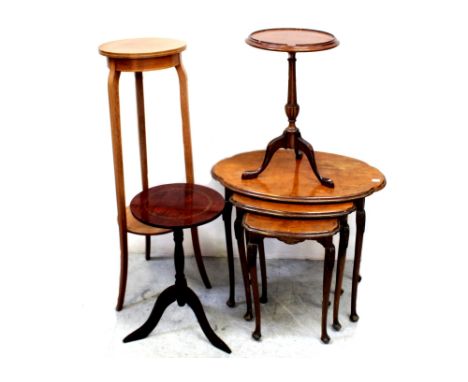 An early/mid-20th century nest of quarter-matched burr walnut tables on acanthus carved cabriole legs and a mahogany circular